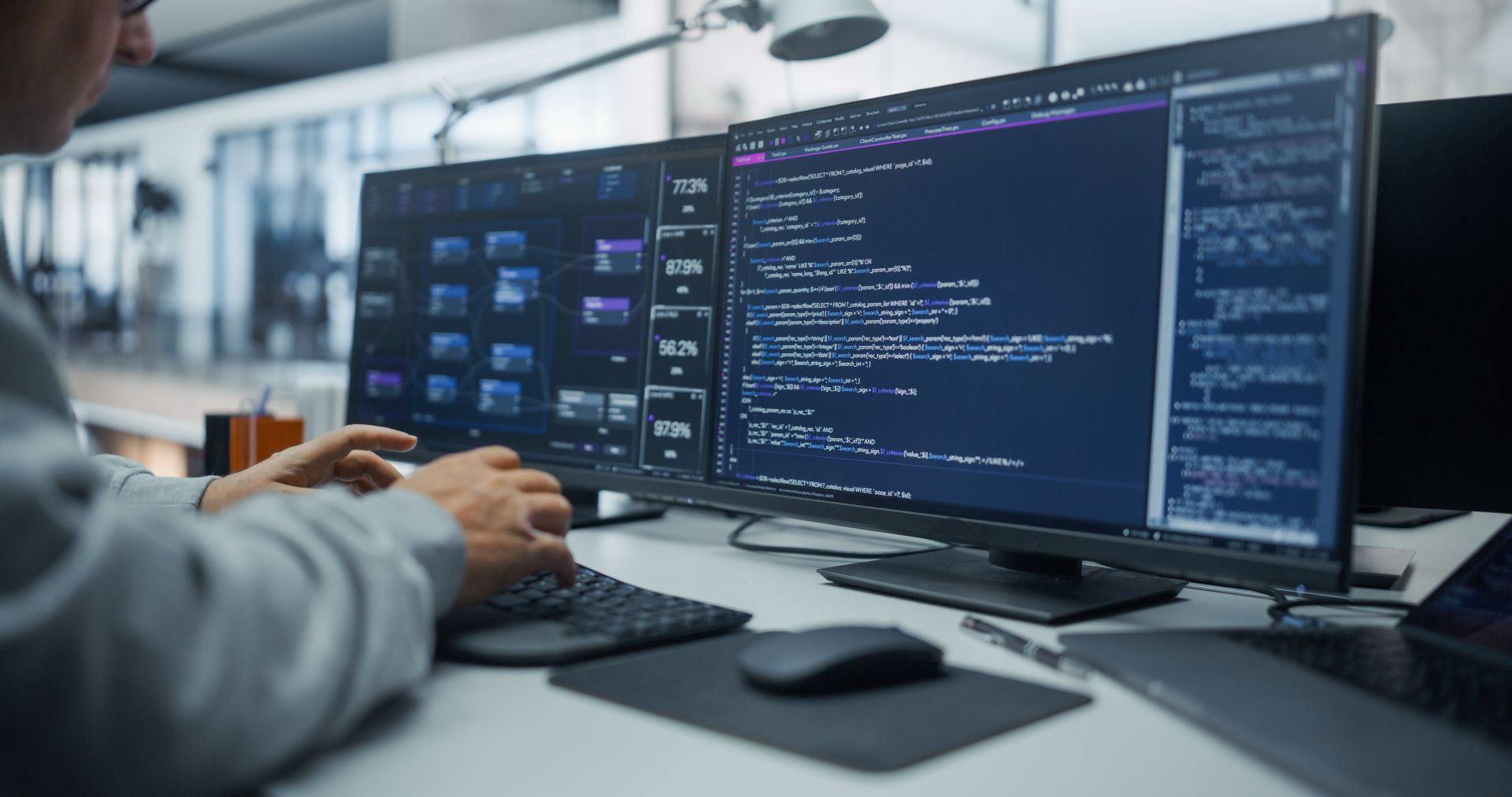 Developer writing custom CFD solver code on a dual-monitor workstation
