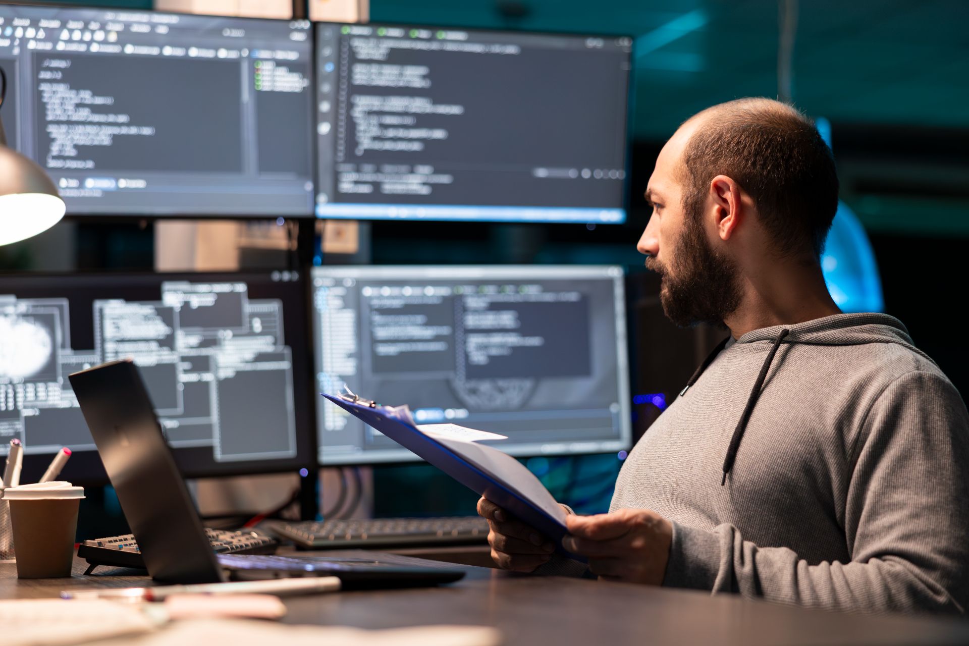 CFD engineer reviewing simulation results across multiple monitors